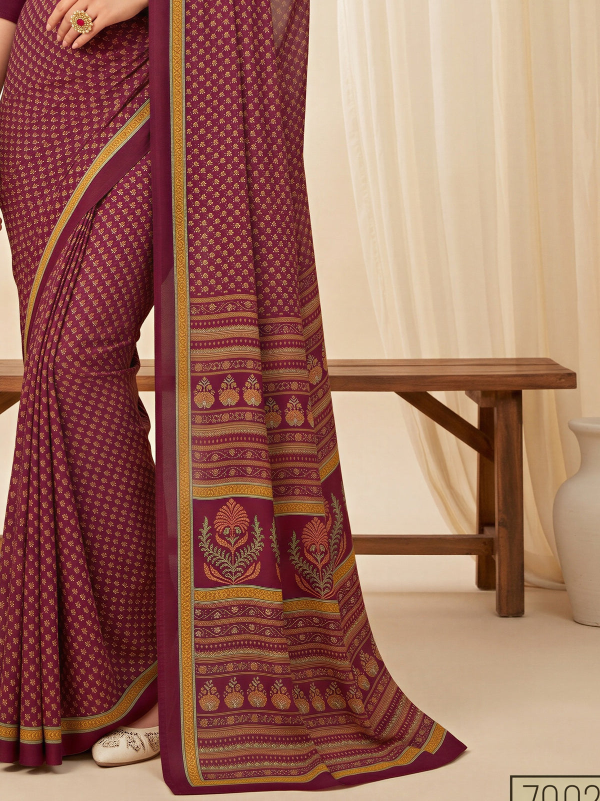 Pallu detail of magenta crepe saree showing batik wax-resist design and printed border