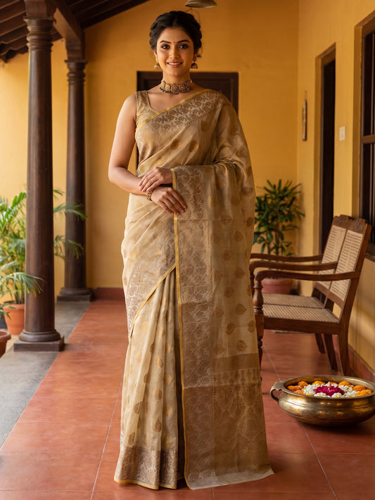 Woman wearing off white silk blend saree with zari butta (metallic motif) work and off white blouse