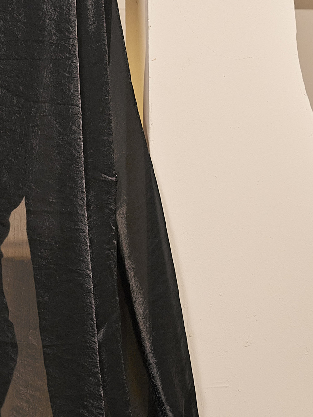 Pallu detail of black satin silk saree showing ornamented surface design and embellished border