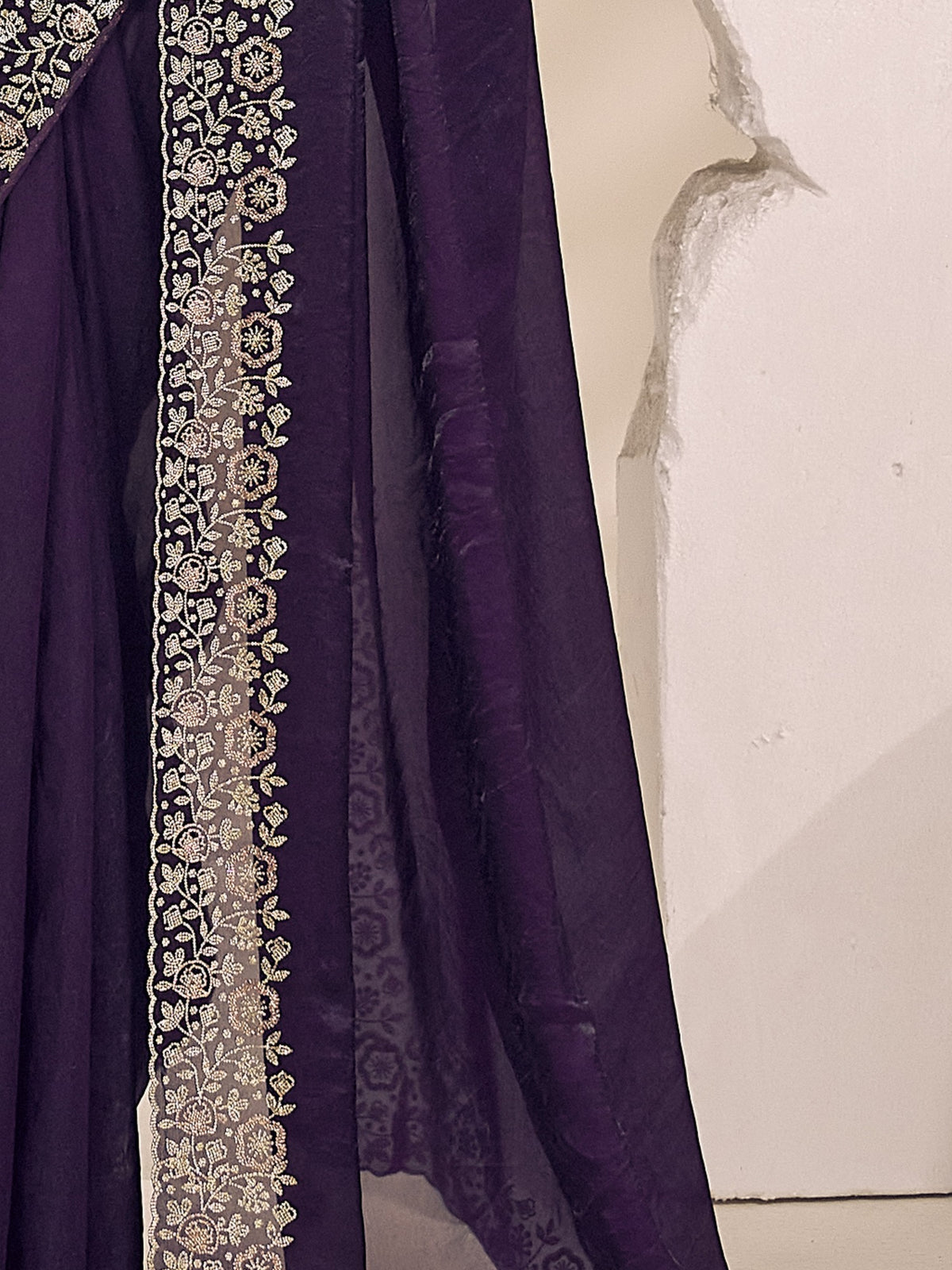 Pallu detail of purple satin silk saree showing clean solid-tone finish and embellished border