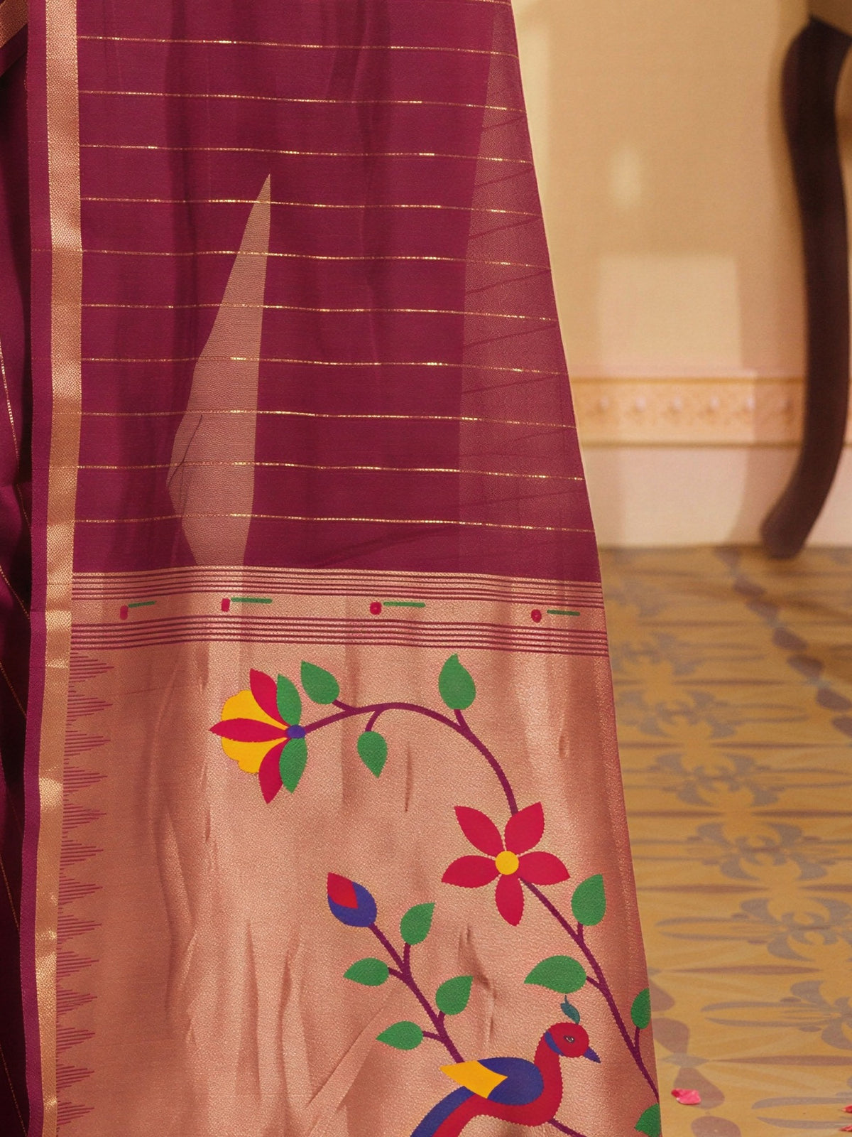 Pallu detail of wine silk blend saree showing striped pattern design and zari border