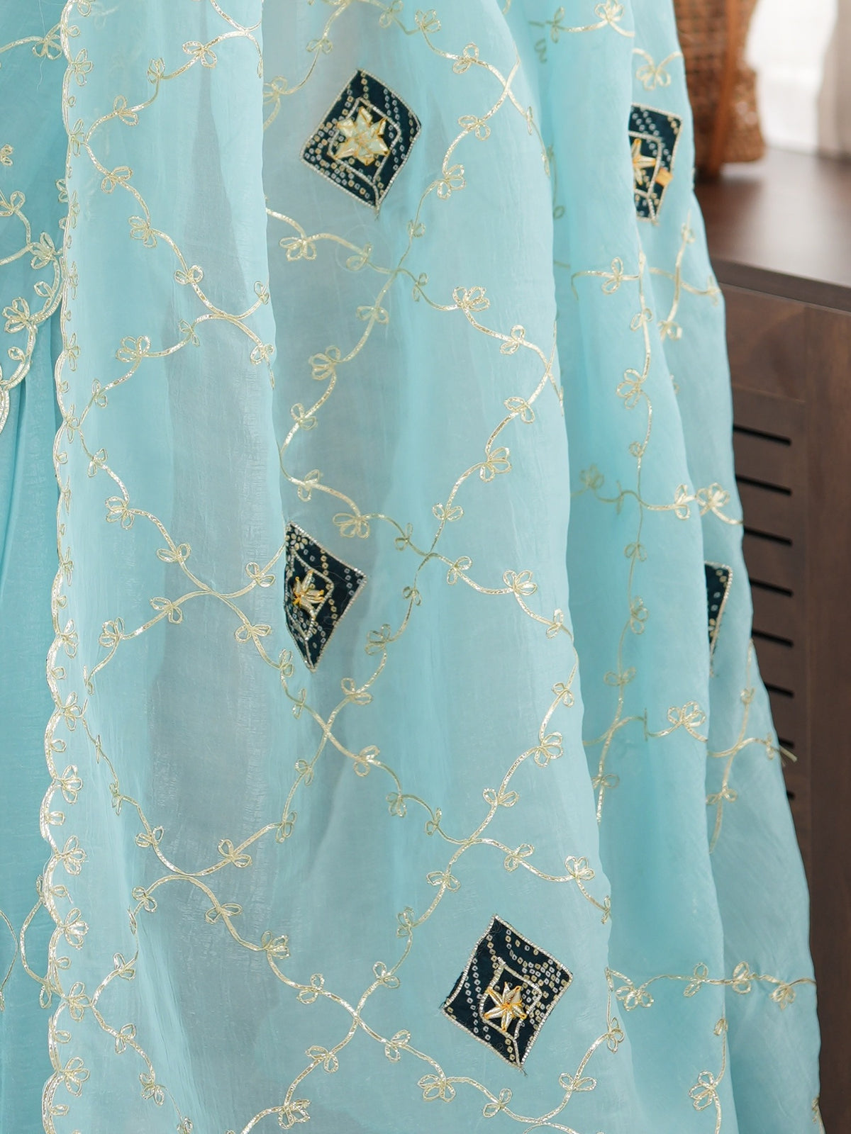 Pallu detail of light blue paper silk saree showing ornamented surface design and embellished border