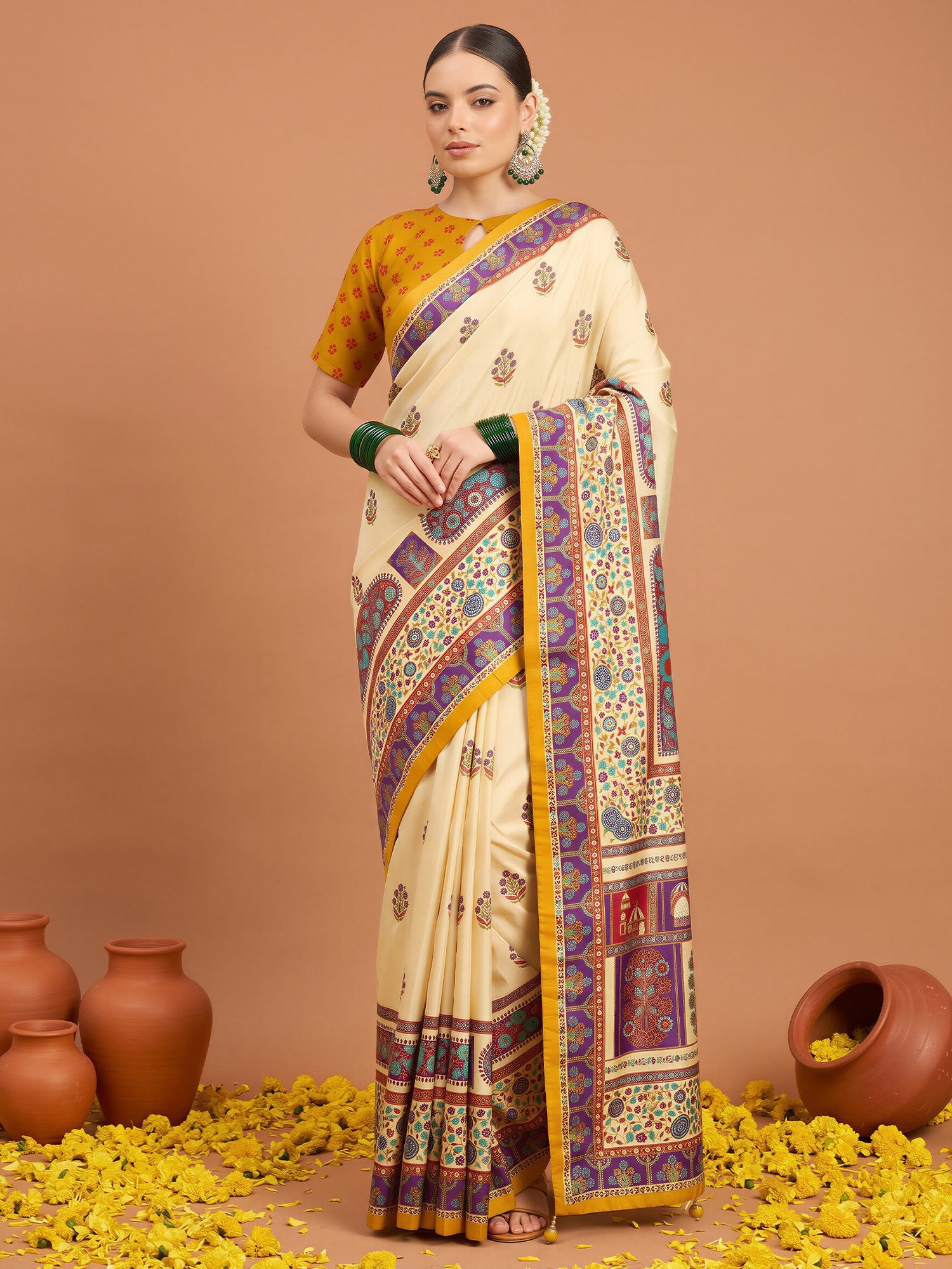 Woman wearing cream silk blend saree with metallic foil print work and yellow blouse