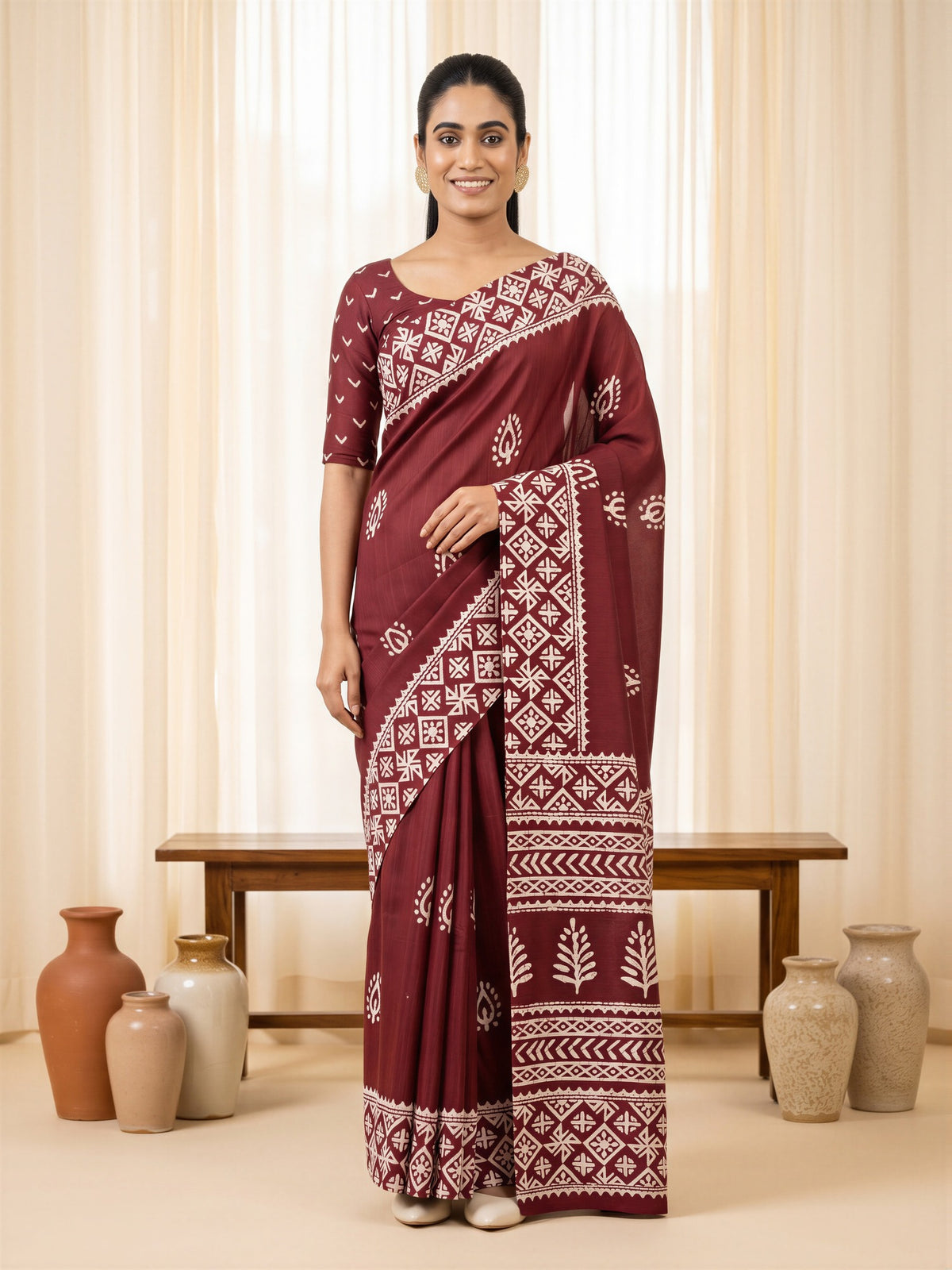 Woman wearing maroon cotton blend saree with bagh block-print motif work and maroon blouse