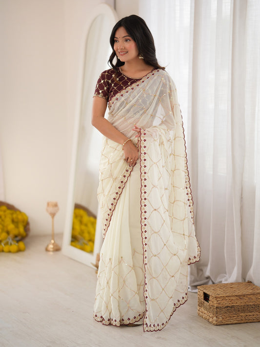 Woman wearing off white georgette saree with ornamented surface design and brown blouse