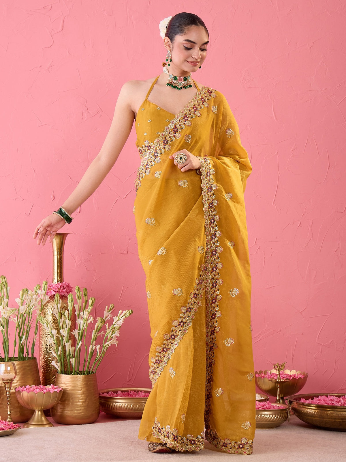 Woman wearing mustard tissue ready to wear saree with ornamented surface design and mustard blouse