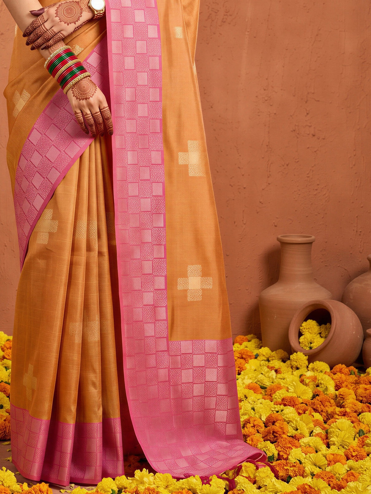 Pallu detail of orange cotton blend saree showing traditional indian motif work and zari border