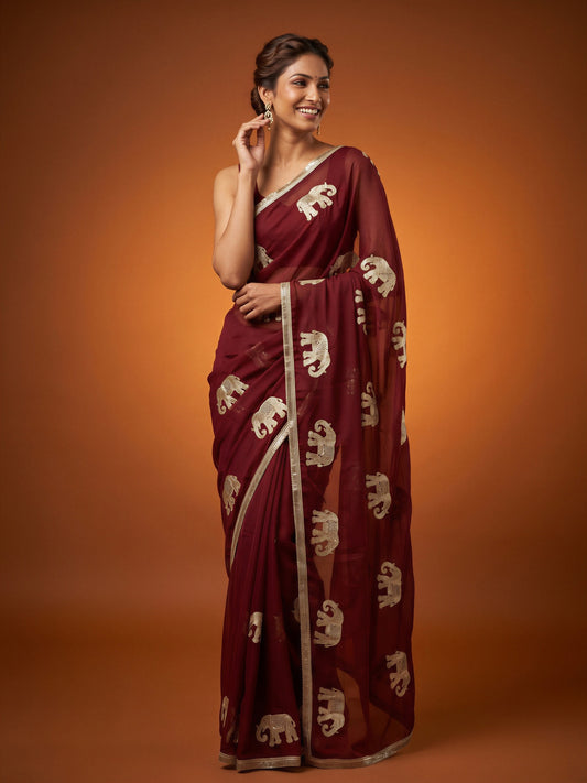 Woman wearing maroon georgette saree with embroidered motif work and maroon blouse