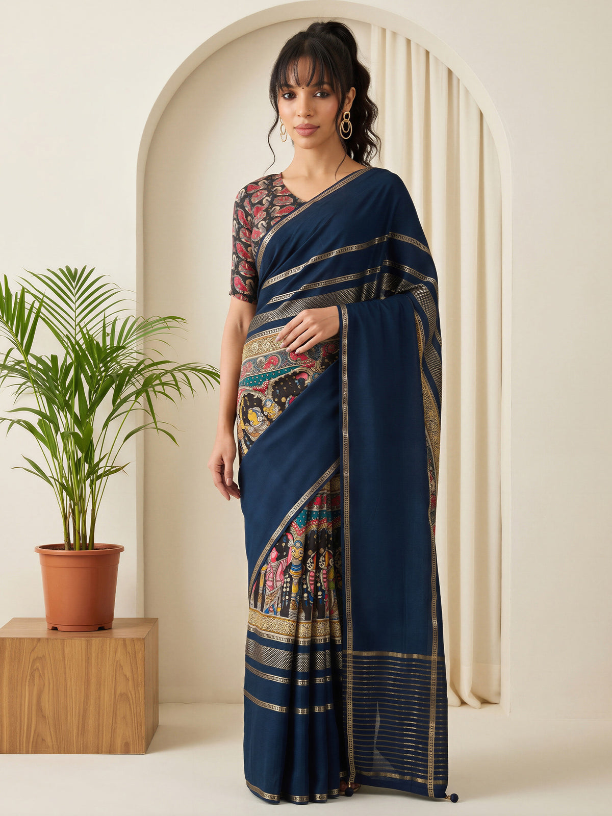 Woman wearing navy blue viscose silk saree with kalamkari narrative motif work and assorted blouse