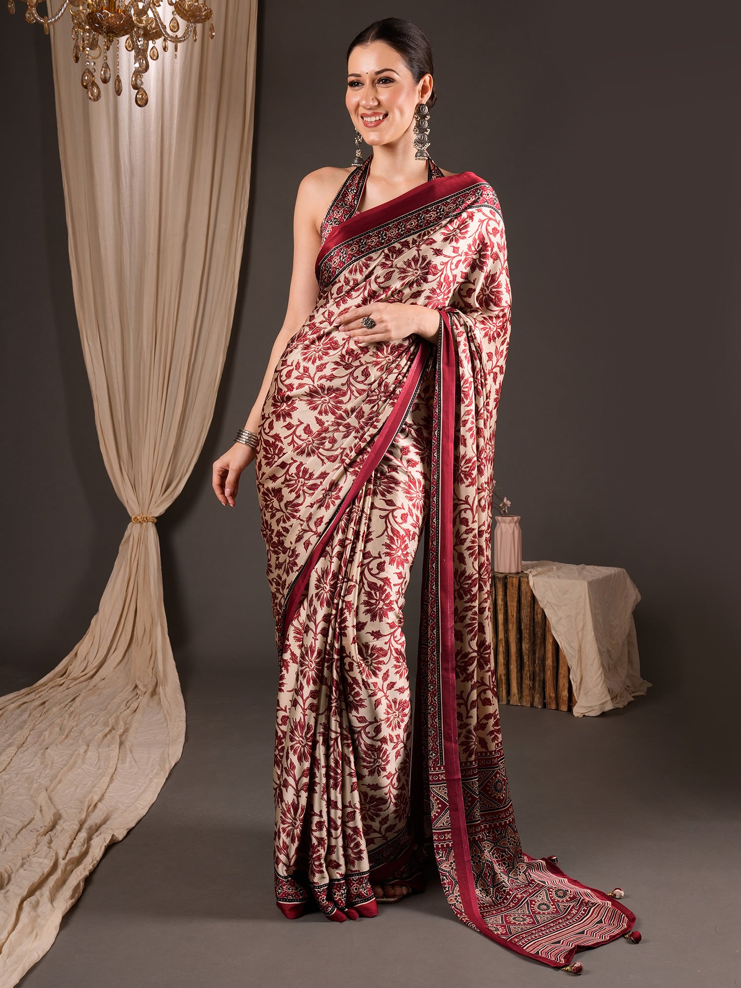 Woman wearing cream satin saree with ajrak block-print motif work and maroon blouse