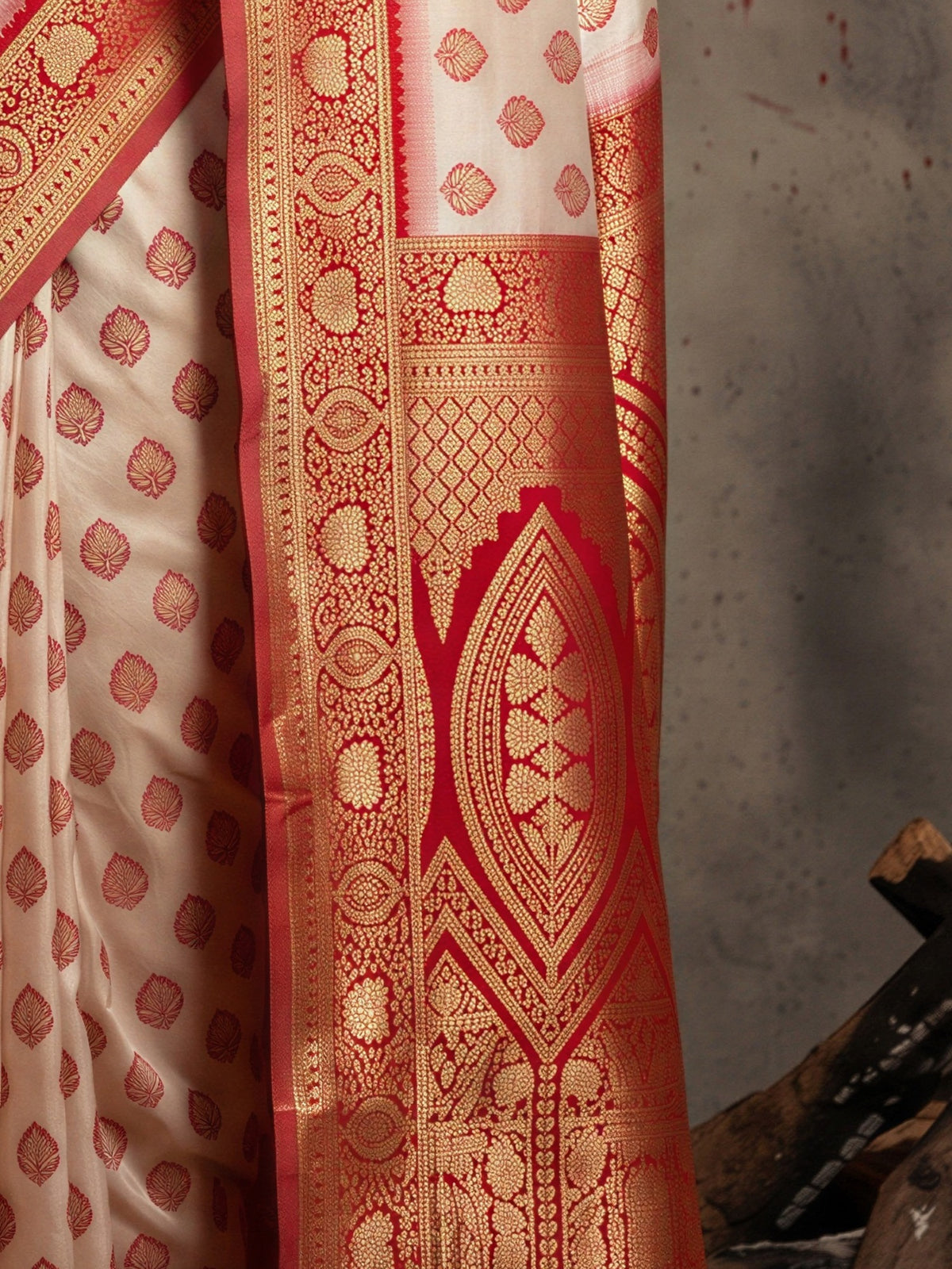 Pallu detail of white banarasi silk saree showing zari butta (metallic motif) work and zari border