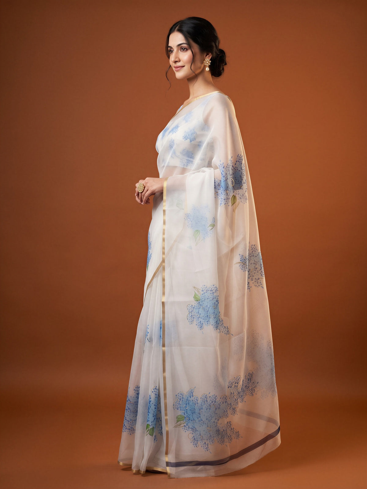 Woman wearing white organza saree with abstract contemporary design and white blouse