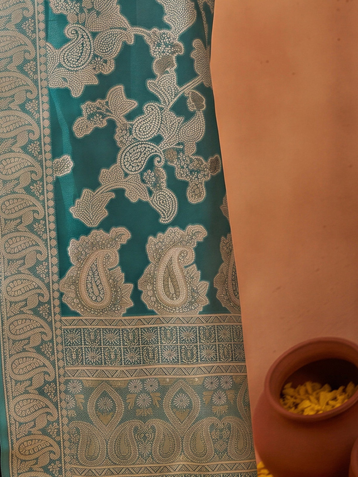 Pallu detail of light blue organza saree showing traditional indian motif work and zari border