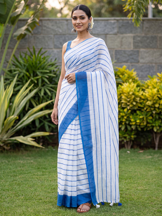 Woman wearing off white cotton linen saree with striped pattern design and blue blouse
