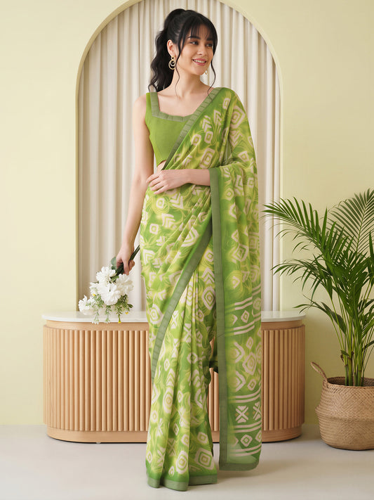 Woman wearing light green georgette saree with batik wax-resist design and light green blouse