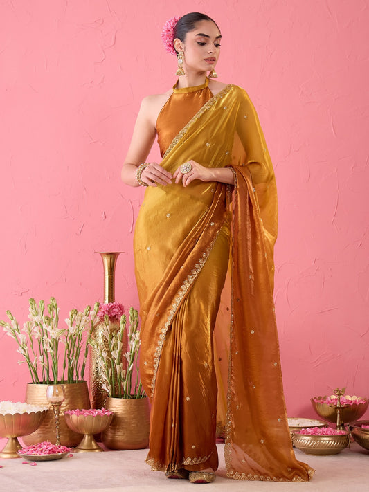 Woman wearing bronze paper silk ready to wear saree with embroidered motif work and bronze blouse