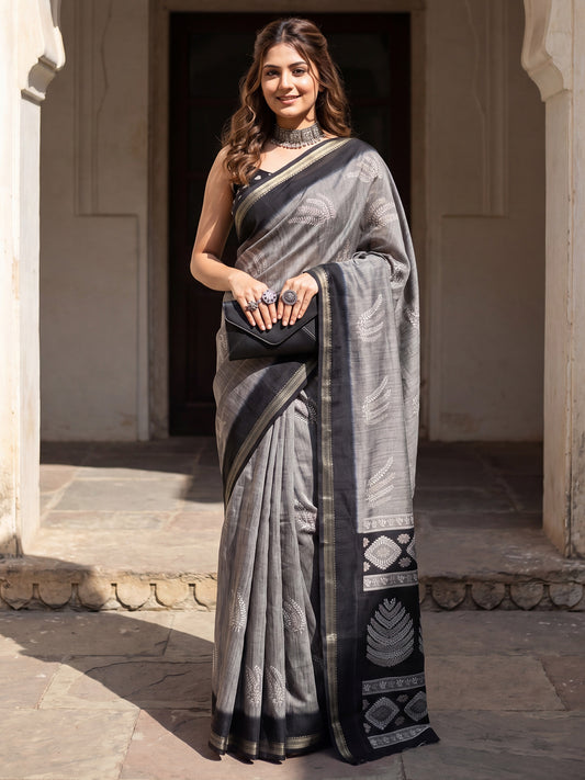 Woman wearing grey tussar silk saree with hand block-printed motifs and black blouse
