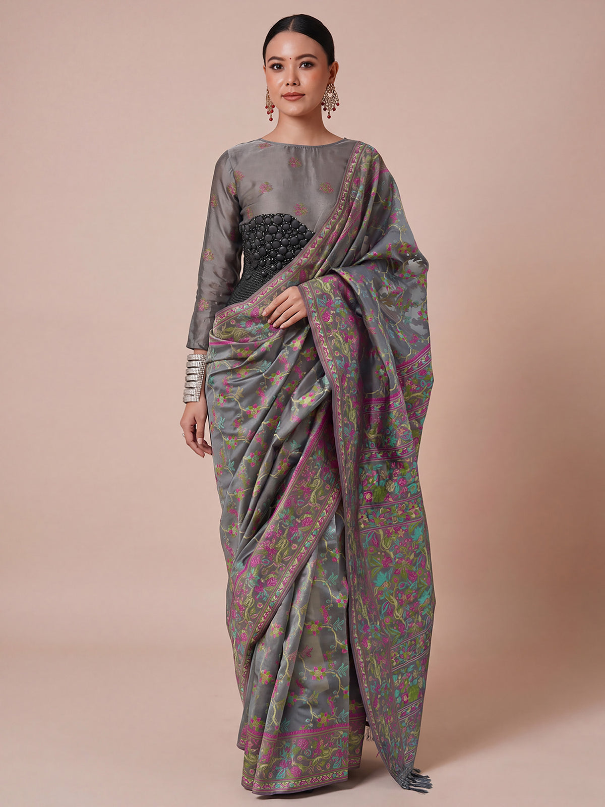 Woman wearing grey organza saree with botanical floral and leaf design and grey blouse