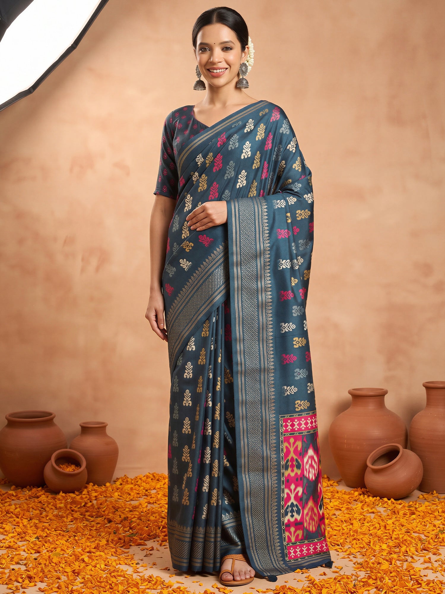 Woman wearing teal blue silk blend saree with metallic foil print work and teal blue blouse