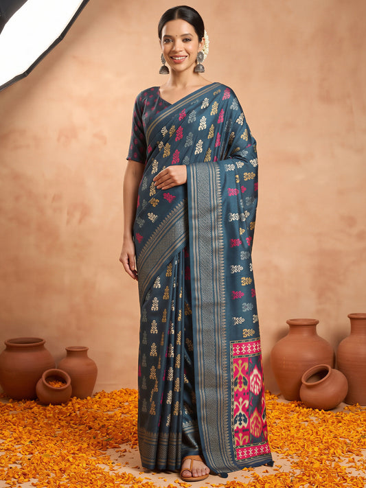 Woman wearing teal blue silk blend saree with metallic foil print work and teal blue blouse
