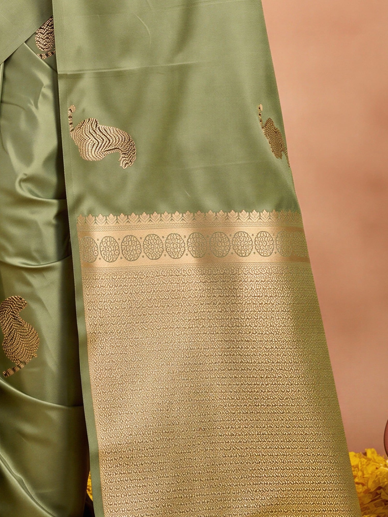 Pallu detail of olive satin silk saree showing animal-print design and no border border