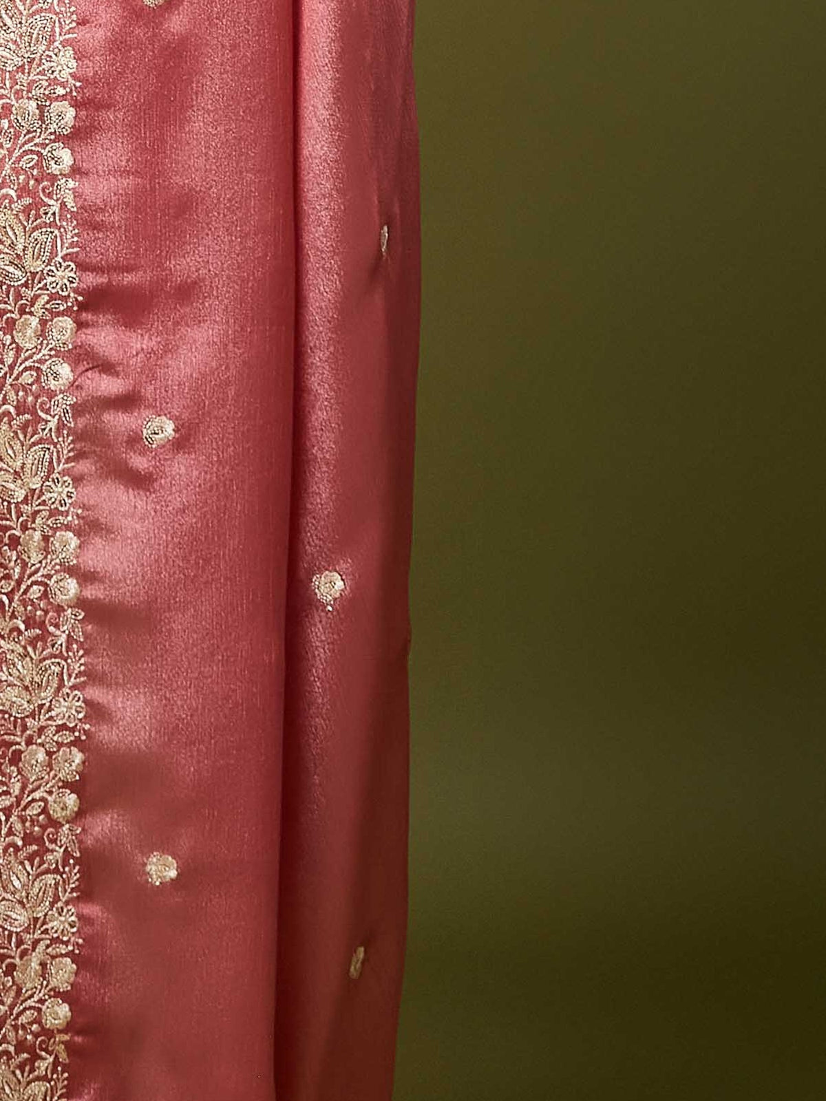 Pallu detail of peach chinnon saree showing embroidered motif work and scallop border