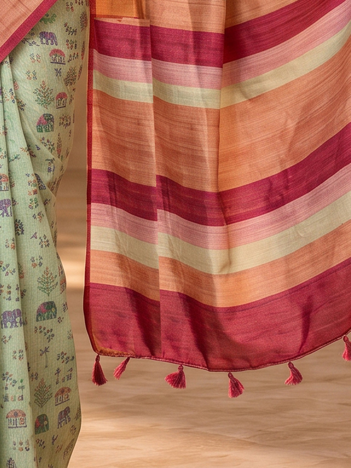 Pallu detail of sea green soft silk saree showing tribal folk-art motifs and printed border