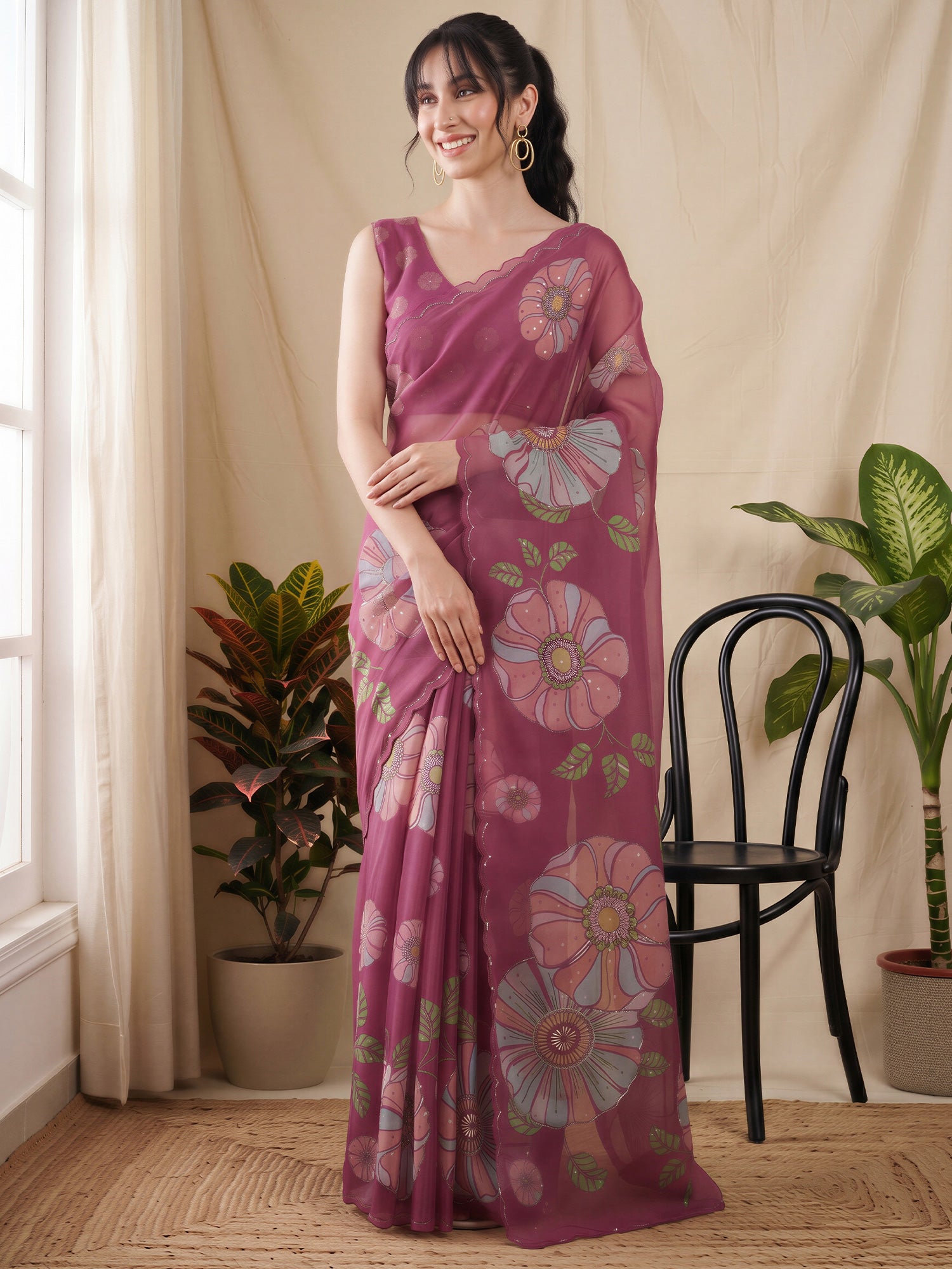Woman wearing magenta organza saree with all-over floral design and magenta blouse