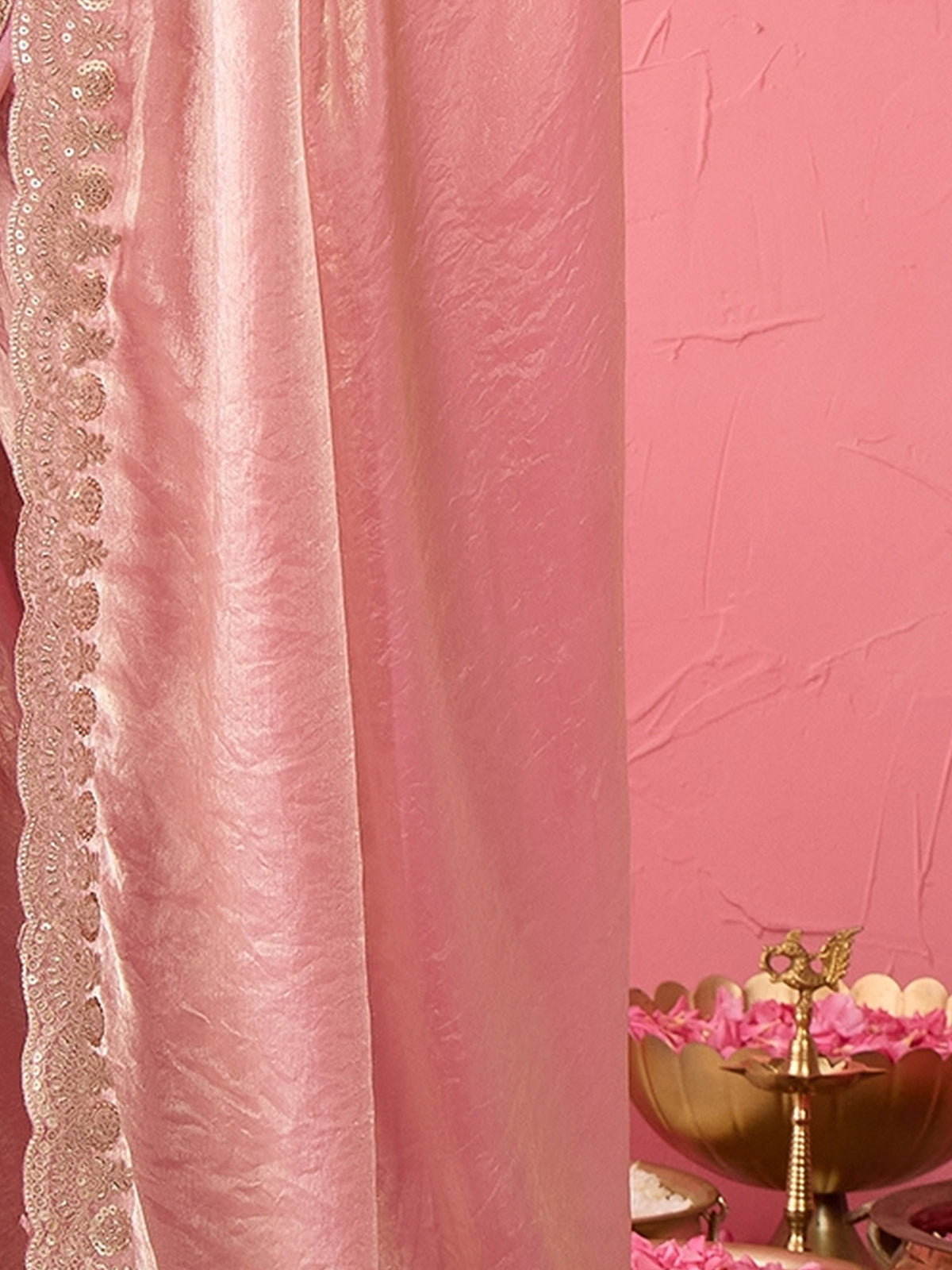 Pallu detail of purple tissue saree showing ornamented surface design and zari border