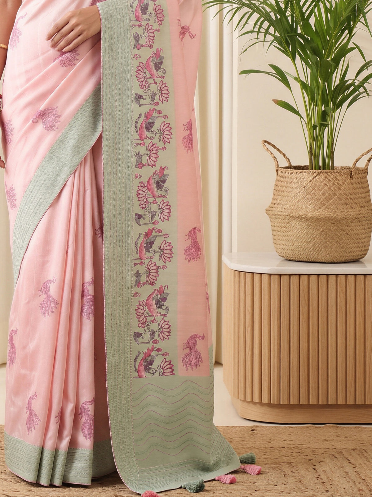 Pallu detail of pink silk blend saree showing peacock motif design and embroidered border