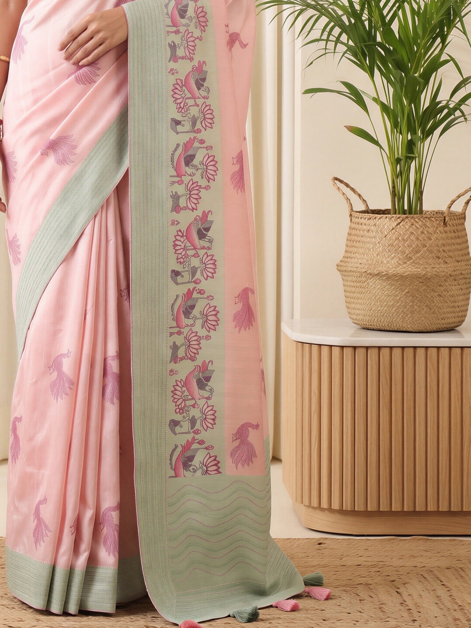 Pallu detail of pink silk blend saree showing traditional indian motif work and embroidered border