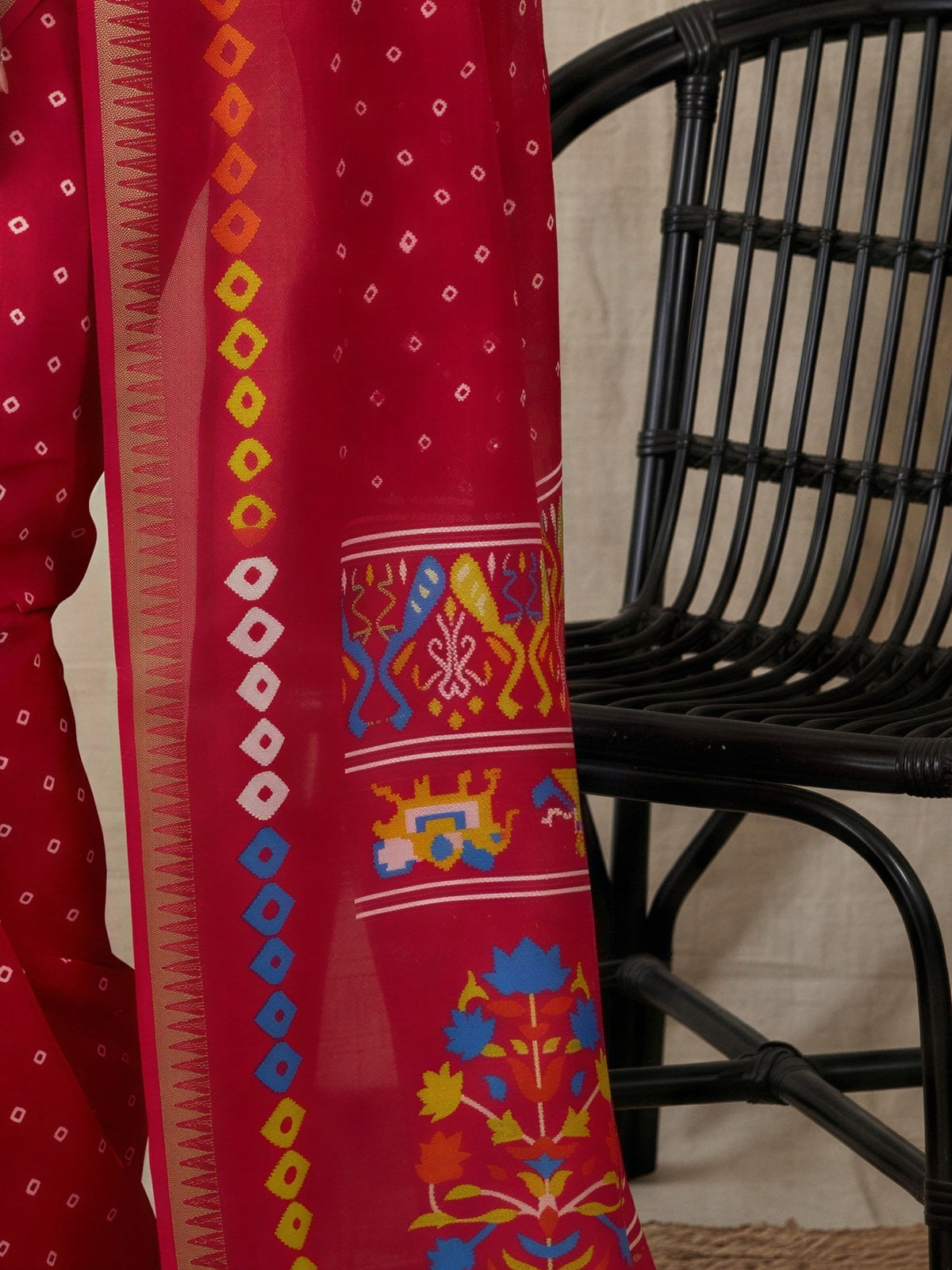Pallu detail of pink georgette saree showing bandhani tie-dye dot work and zari border