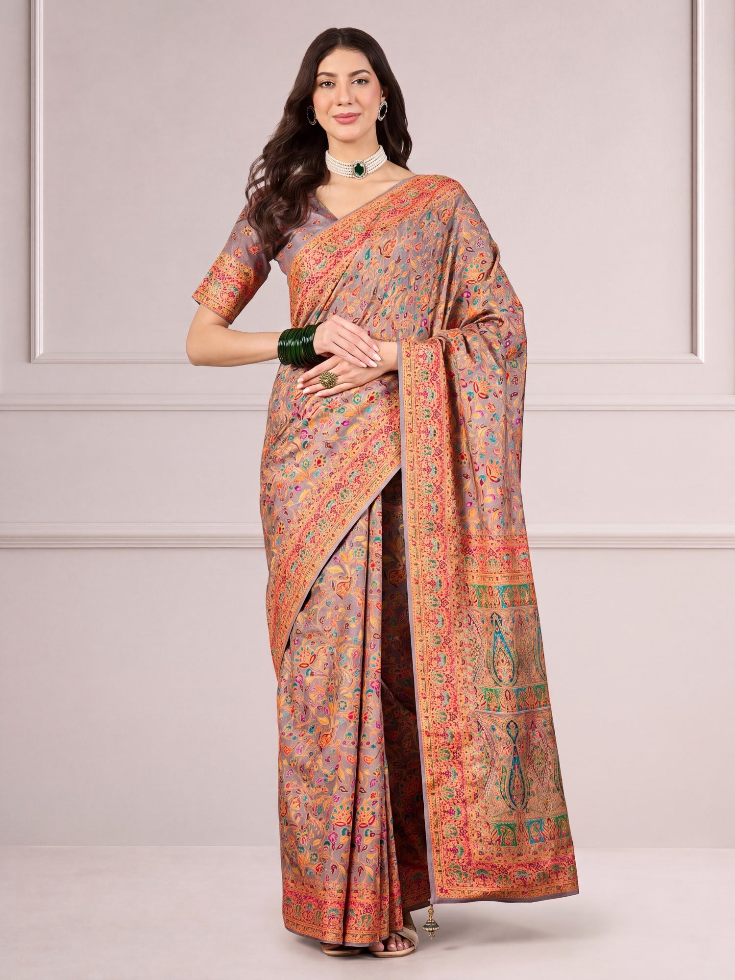 Woman wearing light brown dola silk saree with traditional indian motif work and light brown blouse