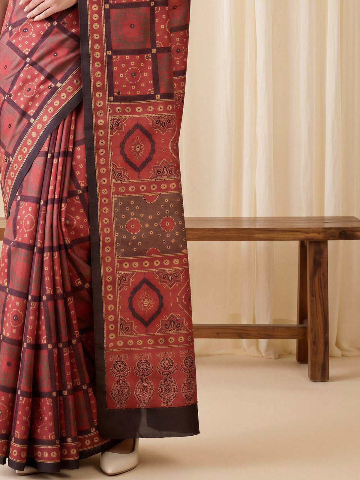 Pallu detail of maroon silk blend saree showing ajrak block-print motif work and embellished border