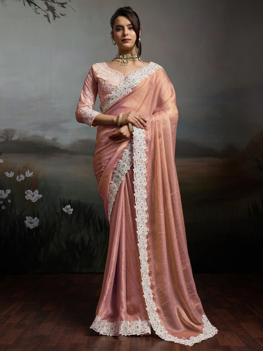 Woman wearing peach satin silk saree with clean solid-tone finish and peach blouse