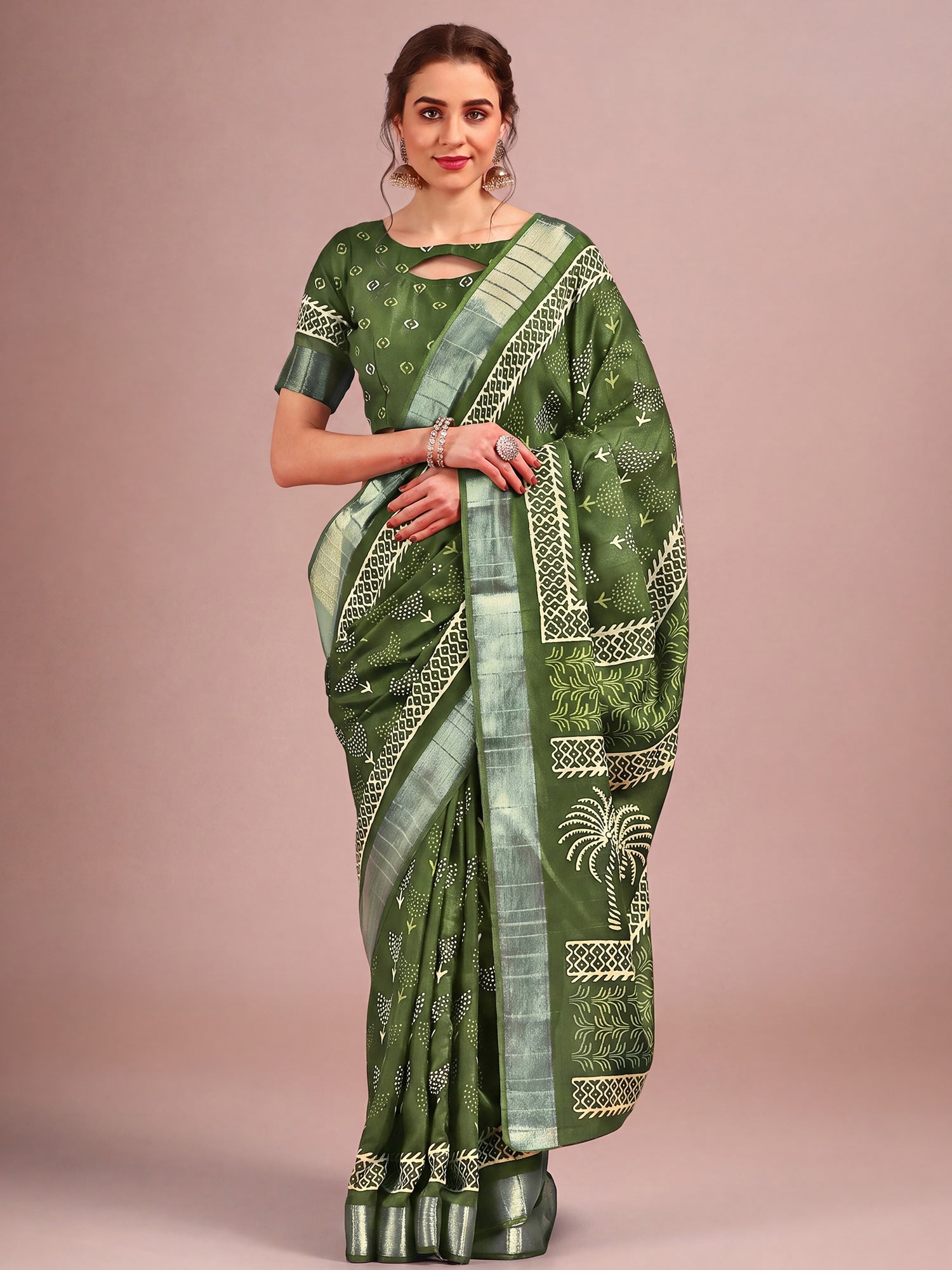 Woman wearing green cotton silk saree with traditional indian motif work and green blouse