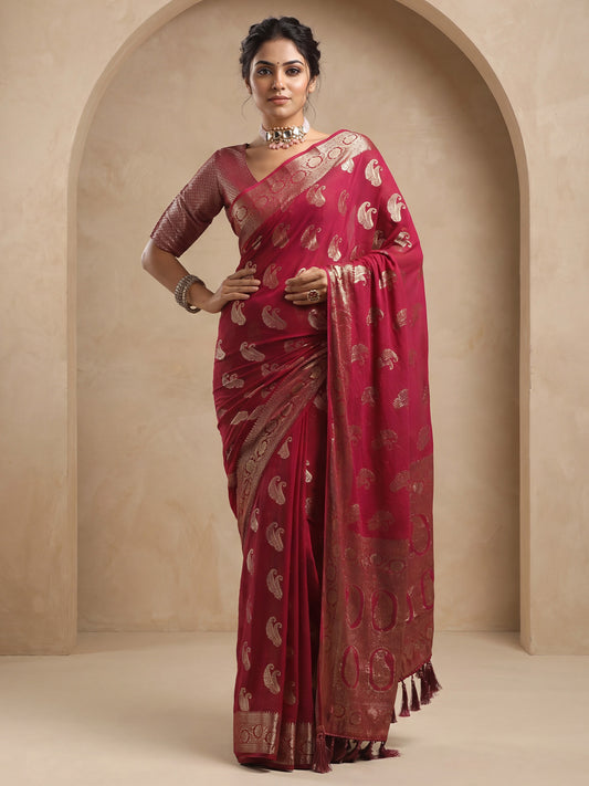 Woman wearing maroon georgette saree with zari butta (metallic motif) work and maroon blouse