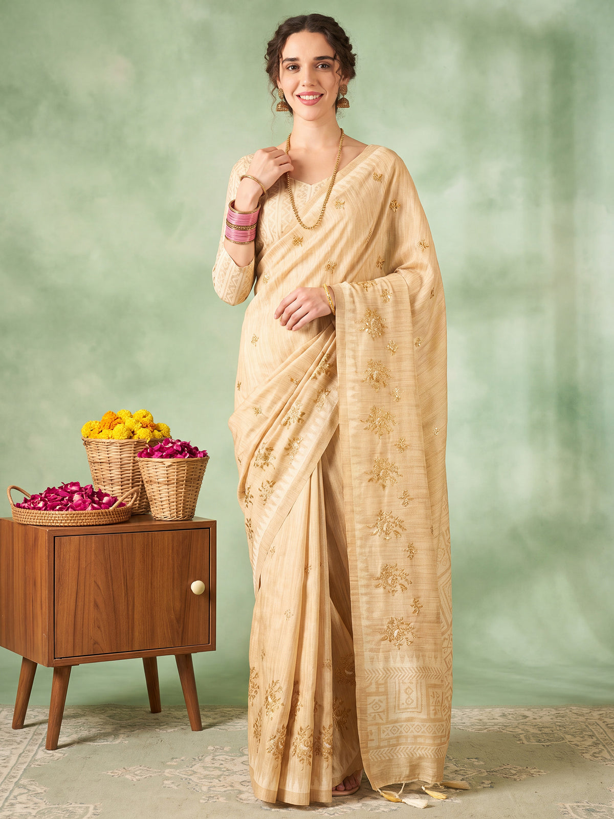 Woman wearing beige silk blend saree with embroidered motif work and beige blouse