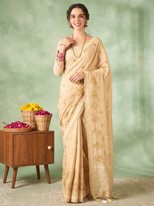 Woman wearing beige silk blend saree with embroidered motif work and beige blouse