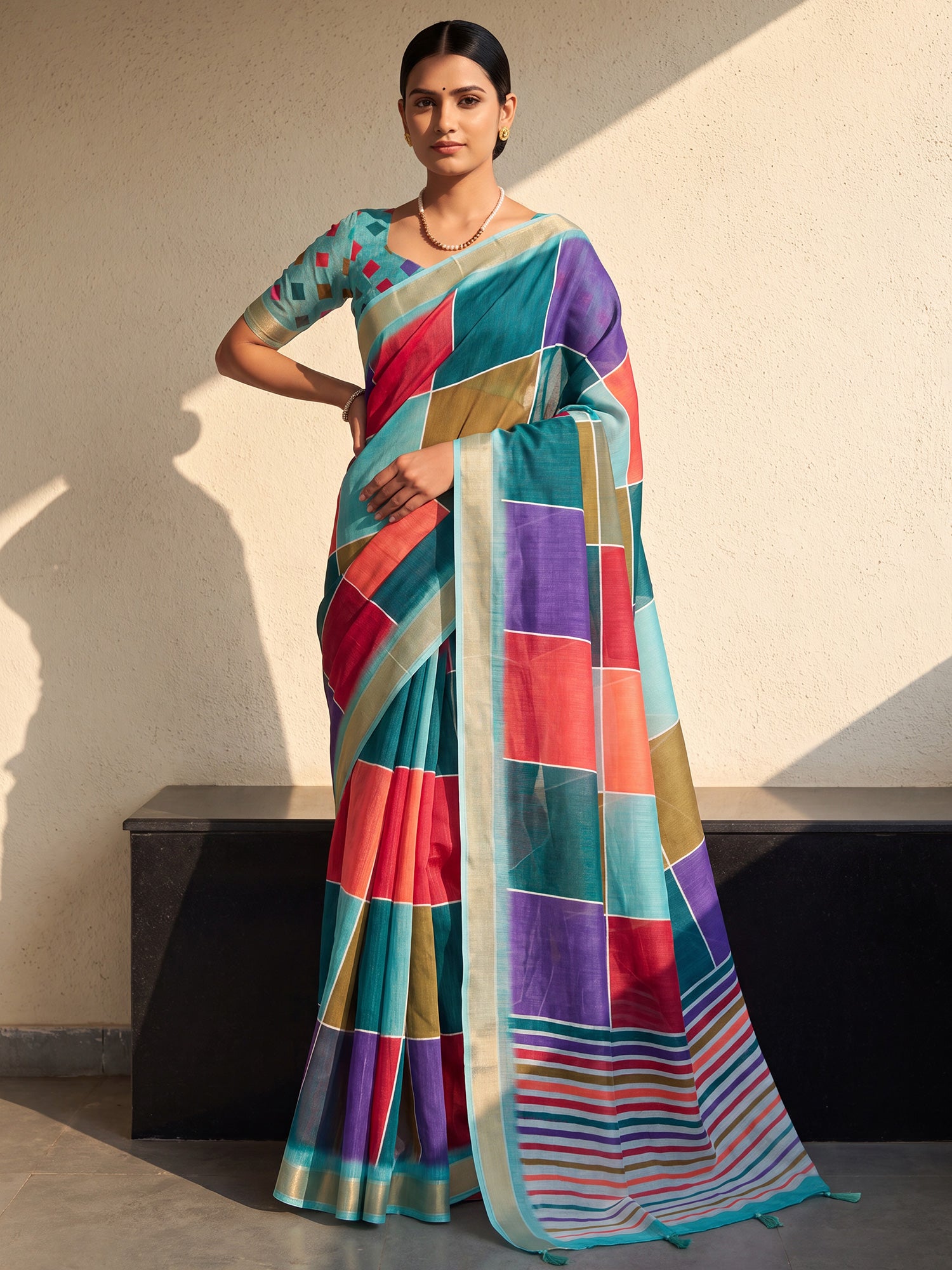 Woman wearing multicolored linen saree with colorblocked design and turquoise blouse