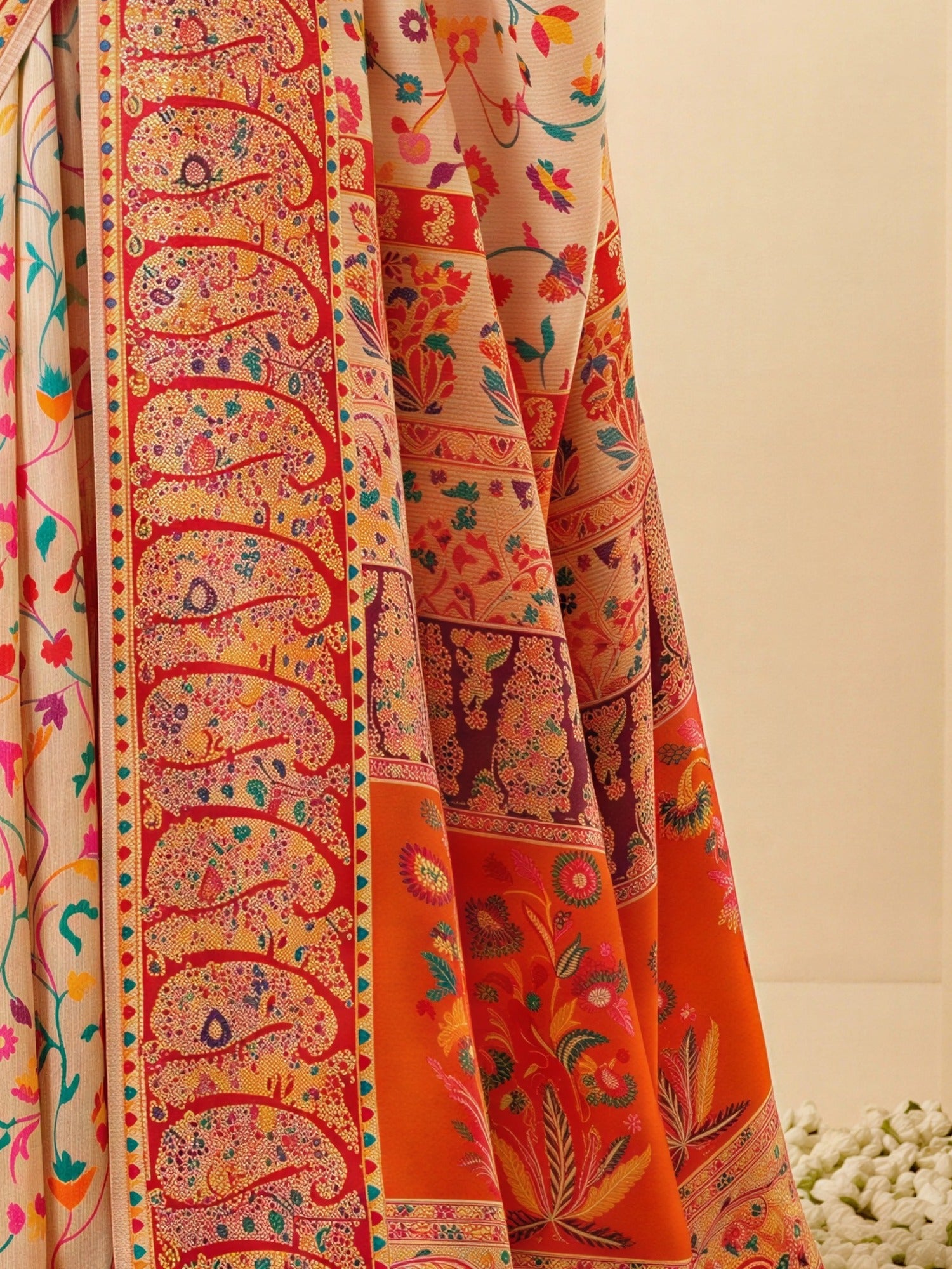 Pallu detail of cream cotton silk saree showing all-over floral design and woven design border