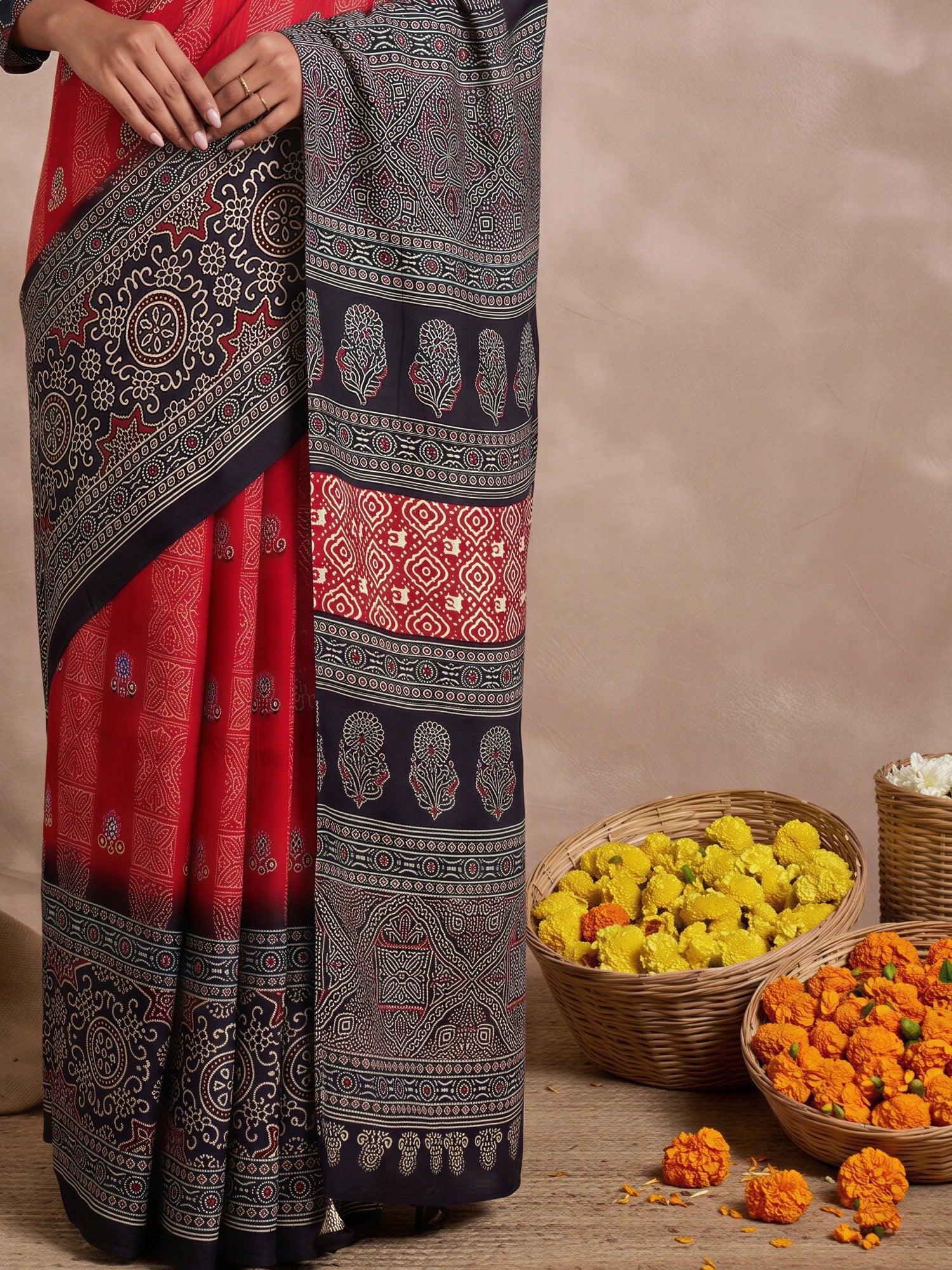 Pallu detail of red viscose silk saree showing ajrak block-print motif work and printed border