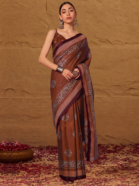 Woman wearing brown cotton saree with batik wax-resist design and brown blouse