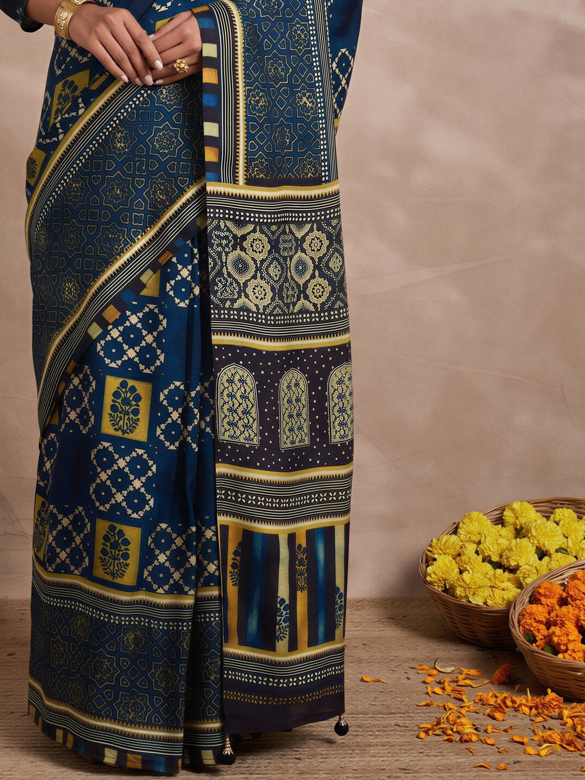 Pallu detail of navy blue viscose silk saree showing traditional indian motif work and printed border