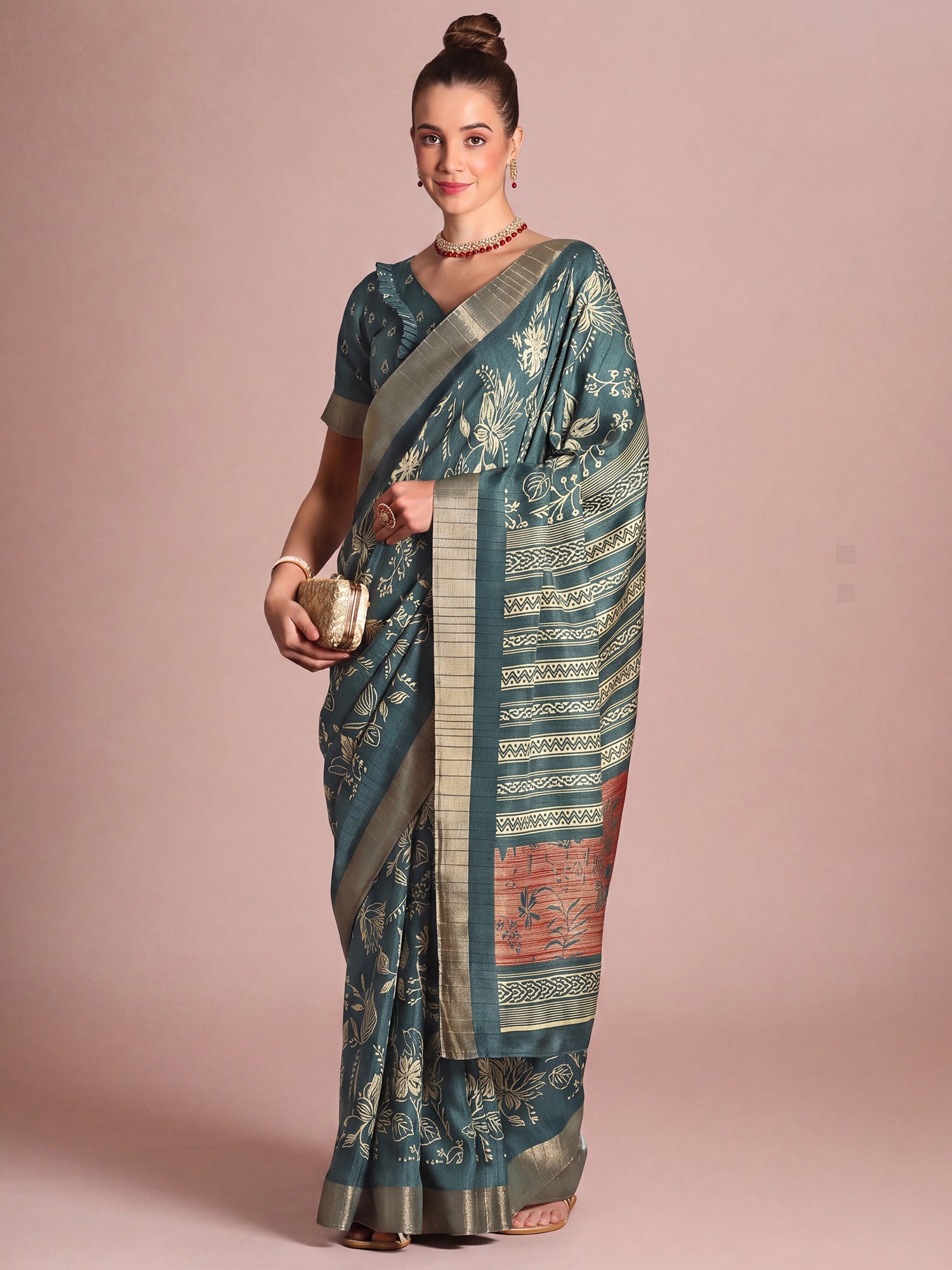 Woman wearing teal blue silk blend saree with botanical floral and leaf design and teal blue blouse