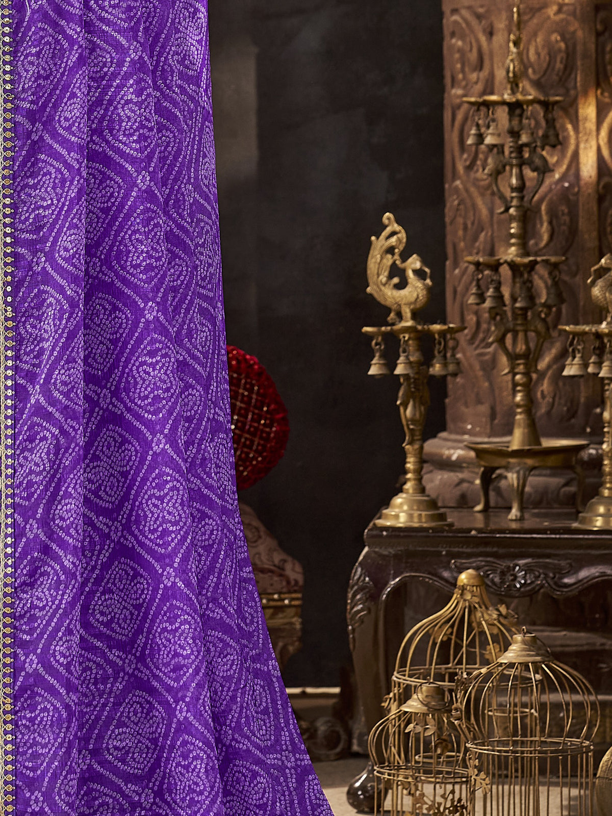 Pallu detail of purple chiffon saree showing bandhani tie-dye dot work and embellished border