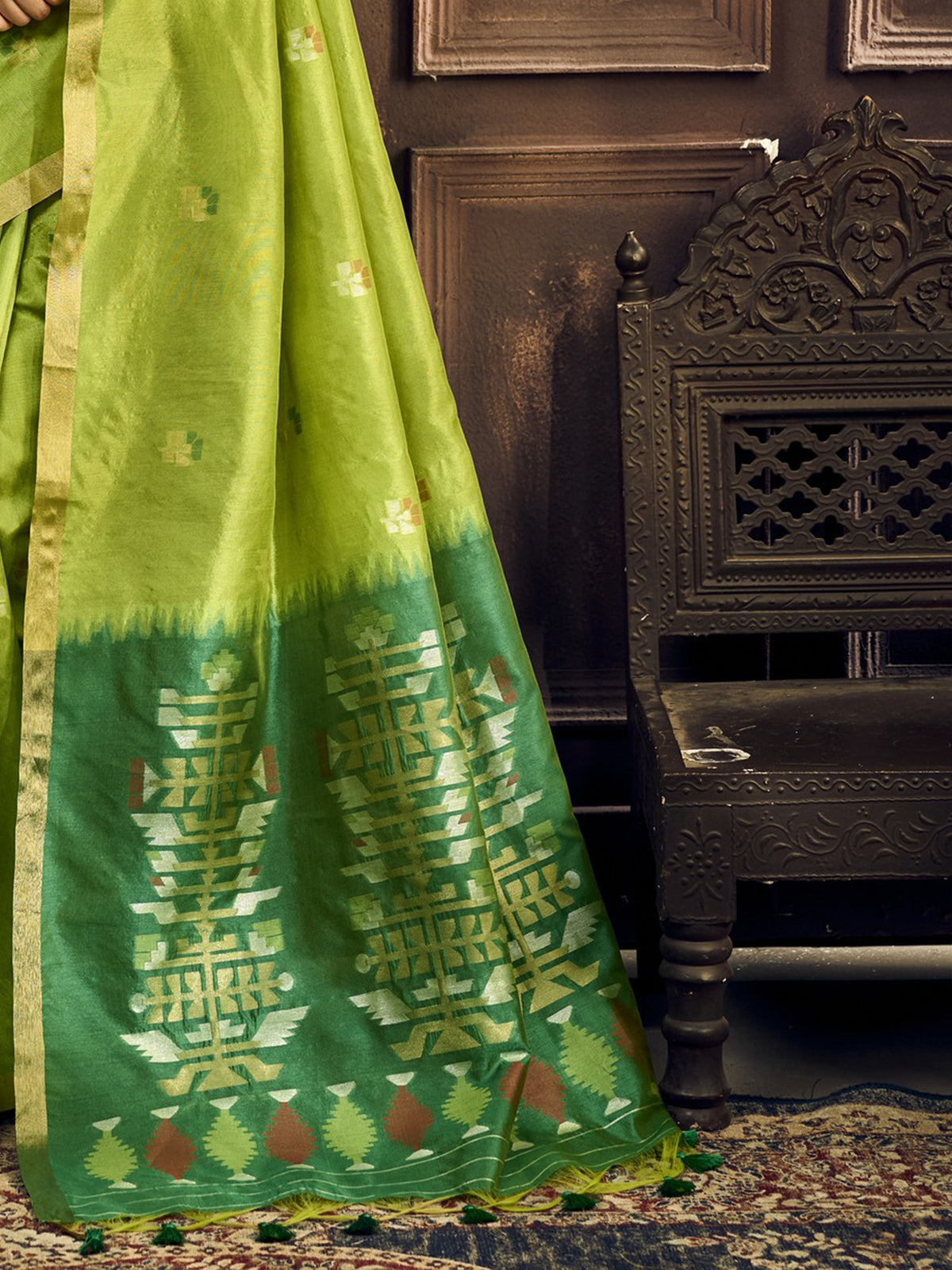 Pallu detail of light green silk blend saree showing zari butta (metallic motif) work and zari border
