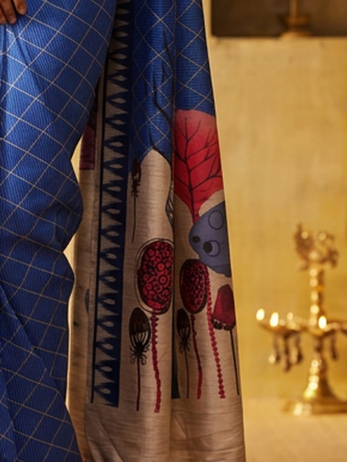 Pallu detail of blue soft silk saree showing geometric pattern design and printed border