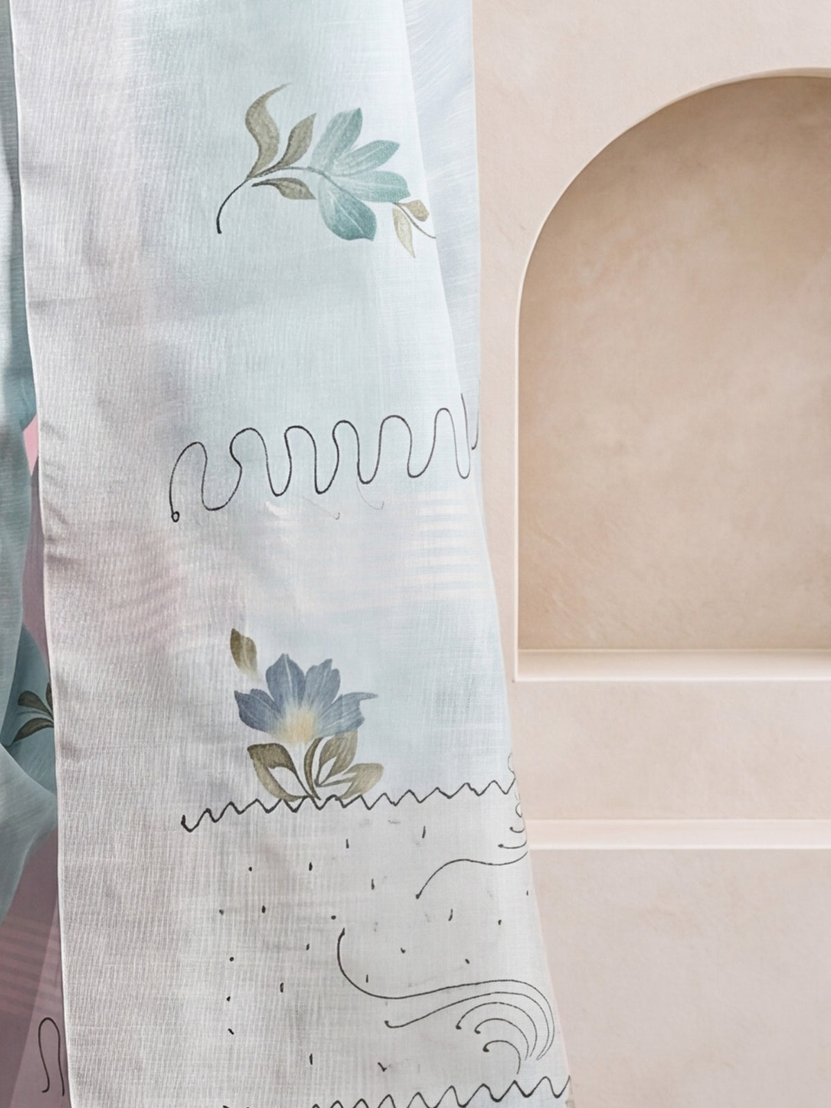 Pallu detail of light blue linen saree showing traditional indian motif work and printed border