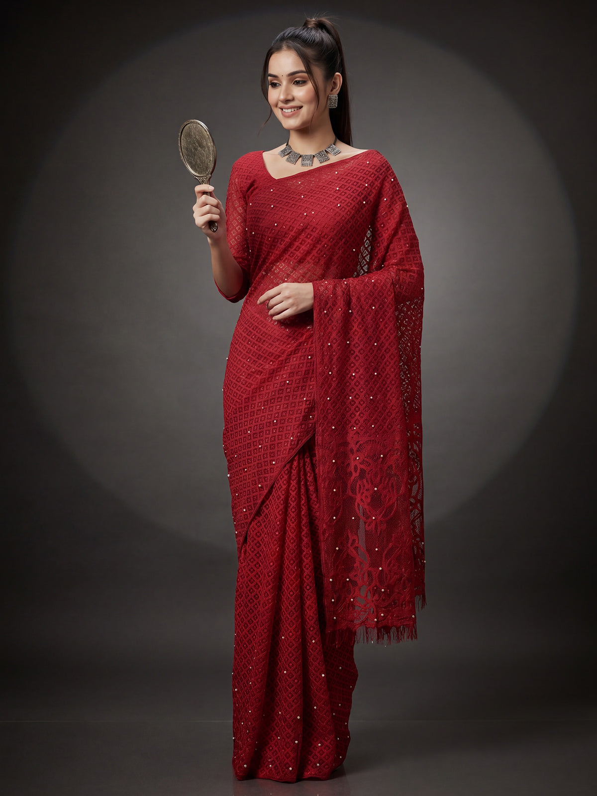 Woman wearing red brasso saree with traditional indian motif work and red blouse